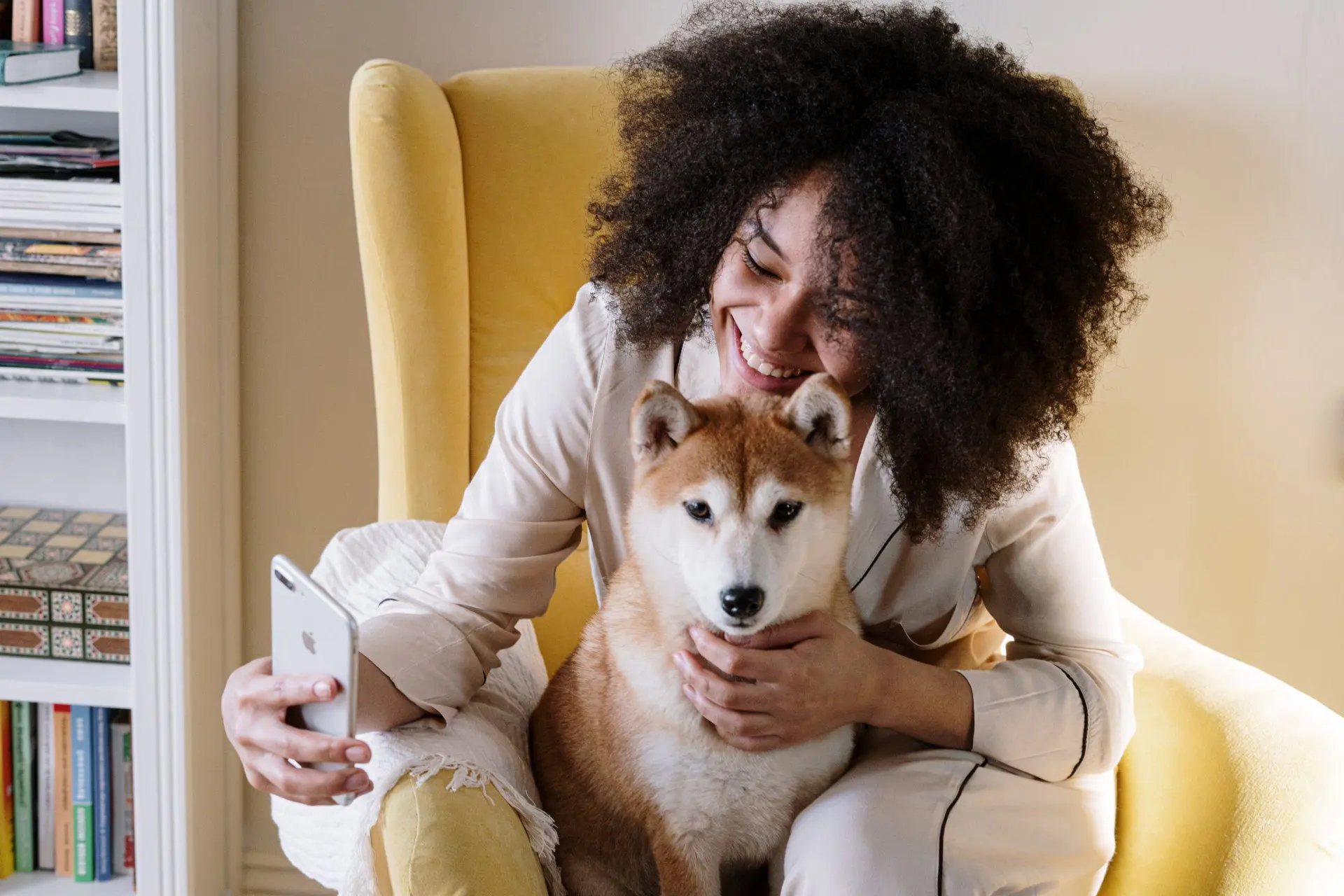 Girl and dog talking on the phone